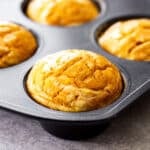 a baked muffin in a muffin pan mold.