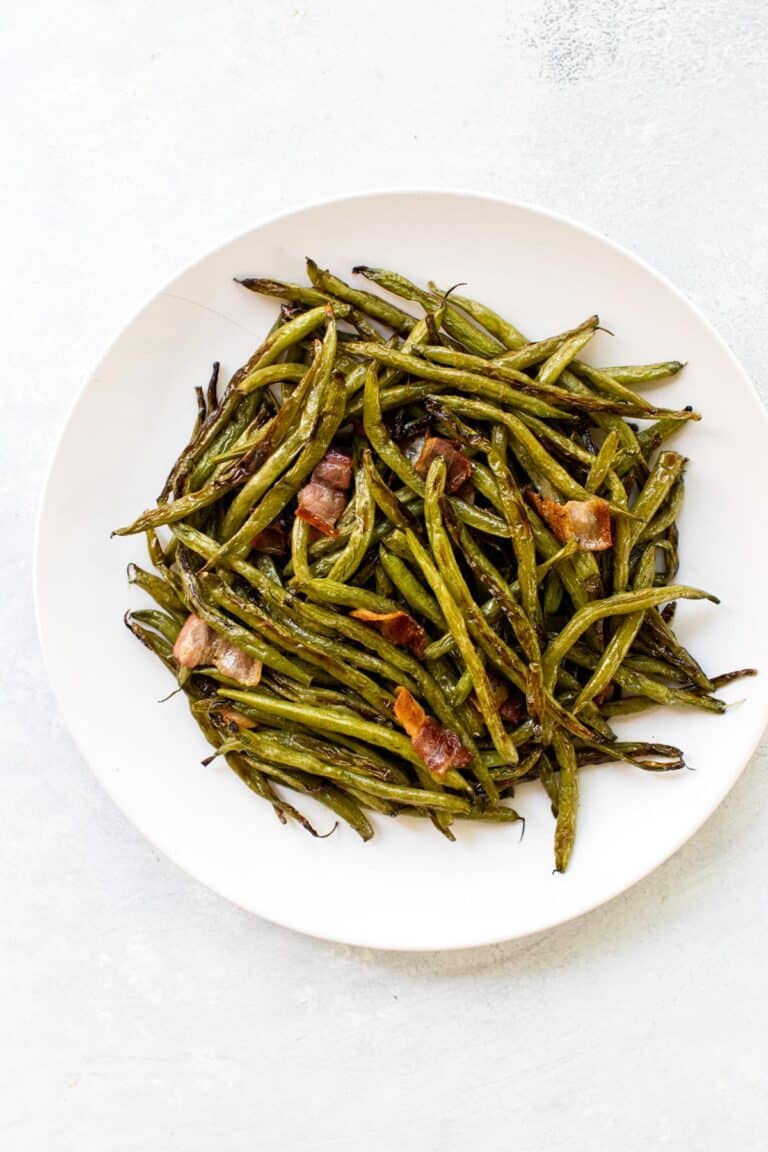 roasted green beans and bacon on a plate.