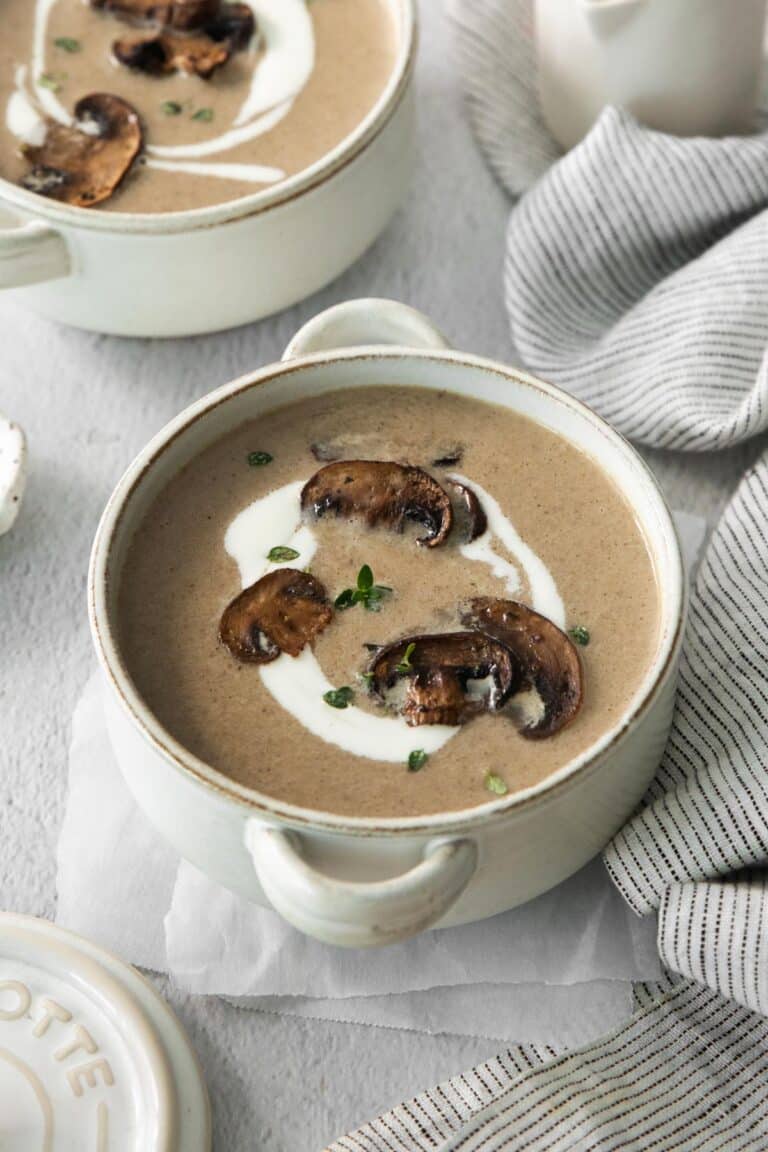 a bowl of soup garnished with mushrooms.