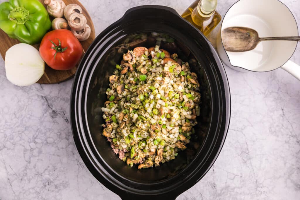 cooked vegetables added to the slow cooker with the meat.