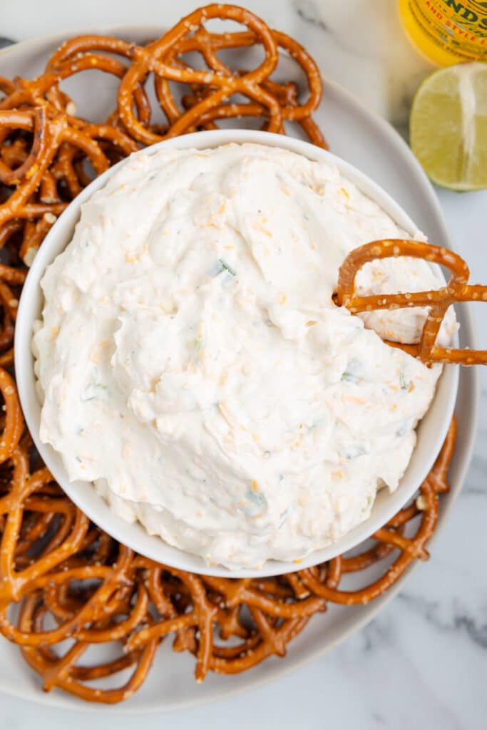 a bowl of beer dip with pretzels.