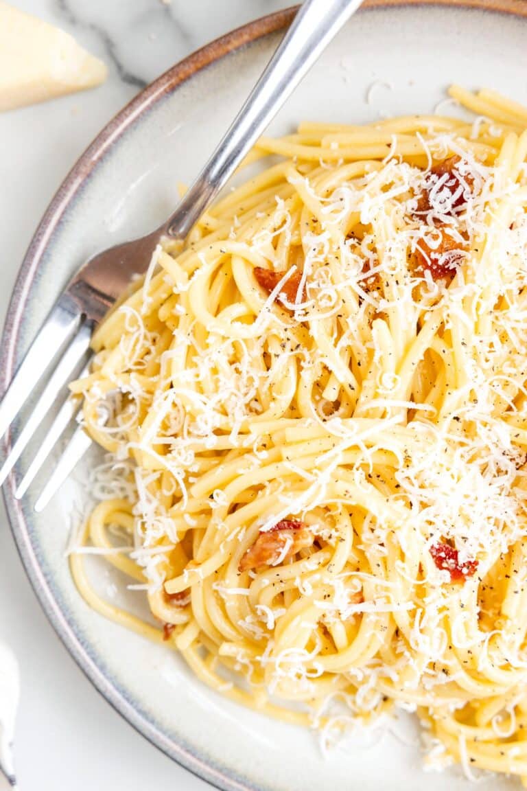 the finished pasta on a plate with a fork.