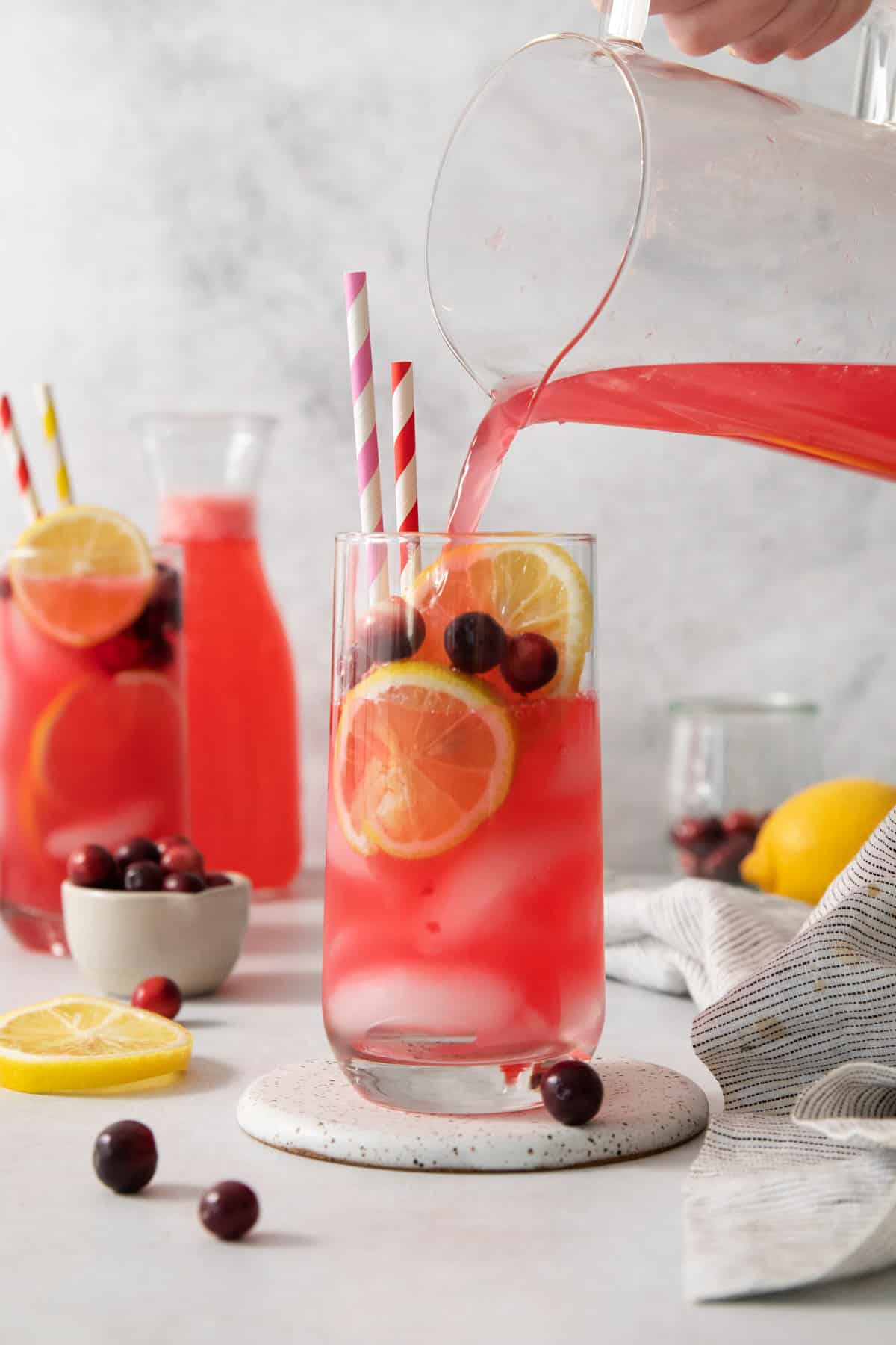 cranberry lemonade being poured into a glass.