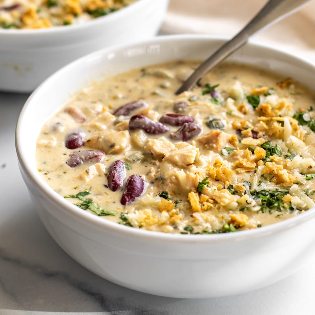 roasted poblano chicken chili in a bowl with a spoon.