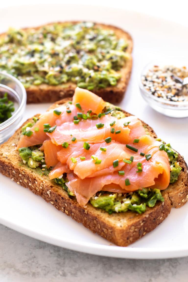 avocado toast topped with smoked salmon.