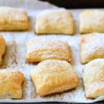 jam and cream cheese pastries on a baking sheet lined with parchment paper.