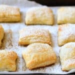 jam and cream cheese pastries on a baking sheet lined with parchment paper.