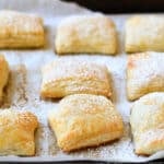 jam and cream cheese pastries on a baking sheet lined with parchment paper.