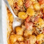 baked gnocchi in a pan with a spoon.