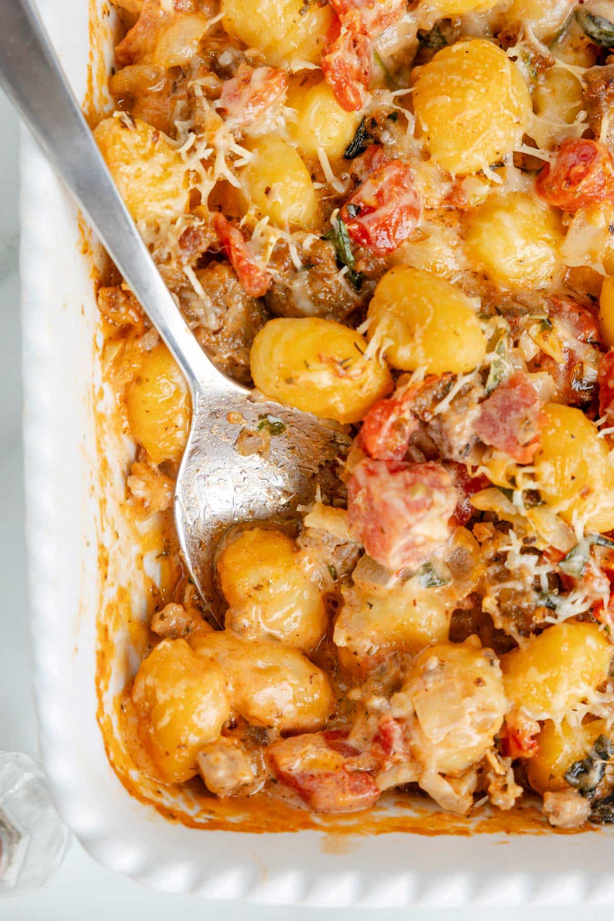 baked gnocchi in a pan with a spoon.