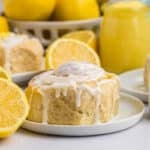 a glazed lemon roll on a plate.