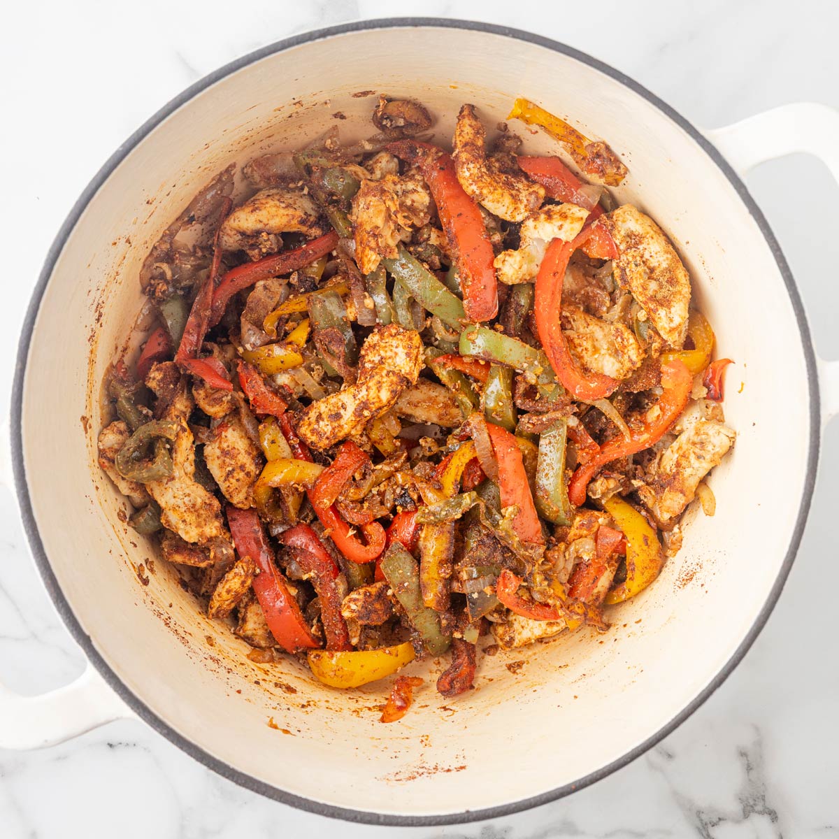 the chicken, peppers, and seasonings in a pot.
