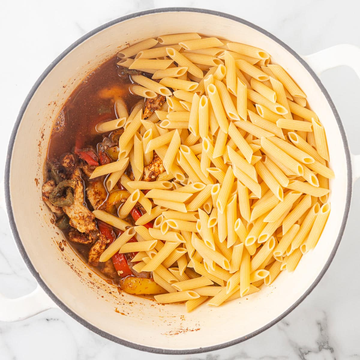 the pasta and broth added to the pan.