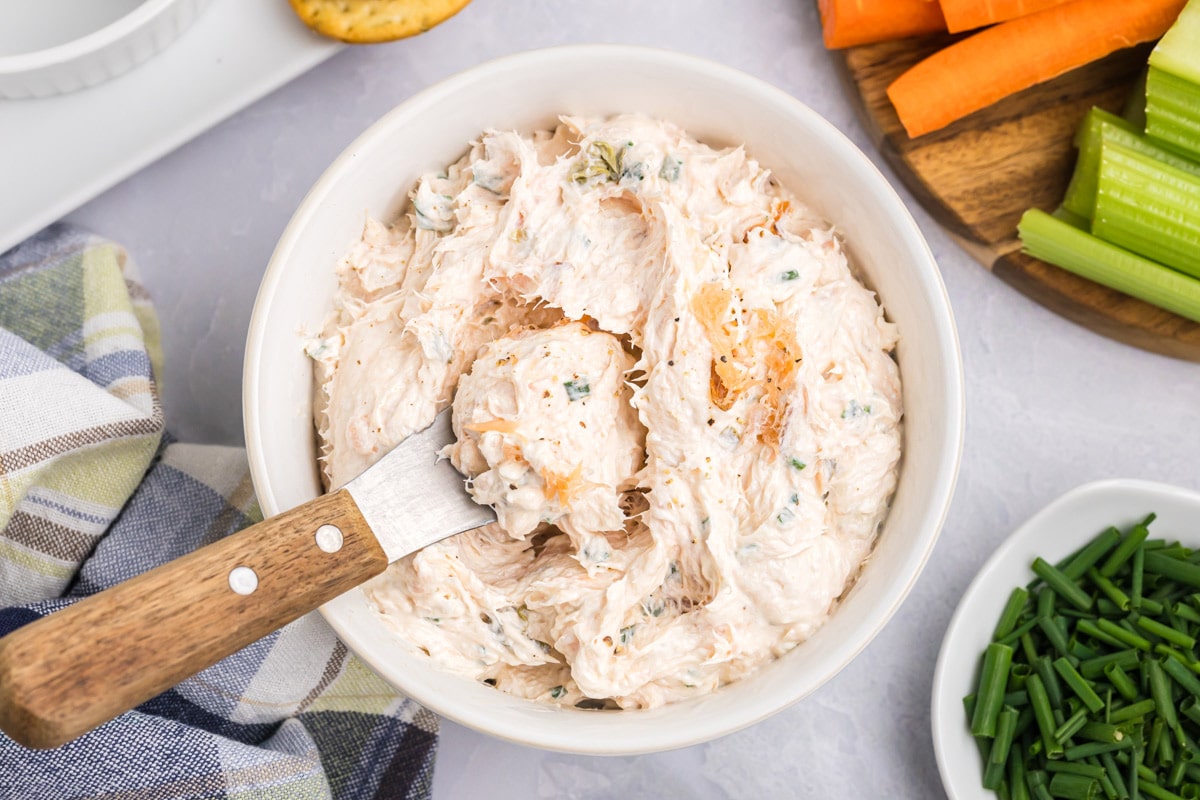 salmon spread in a bowl with a spreader.