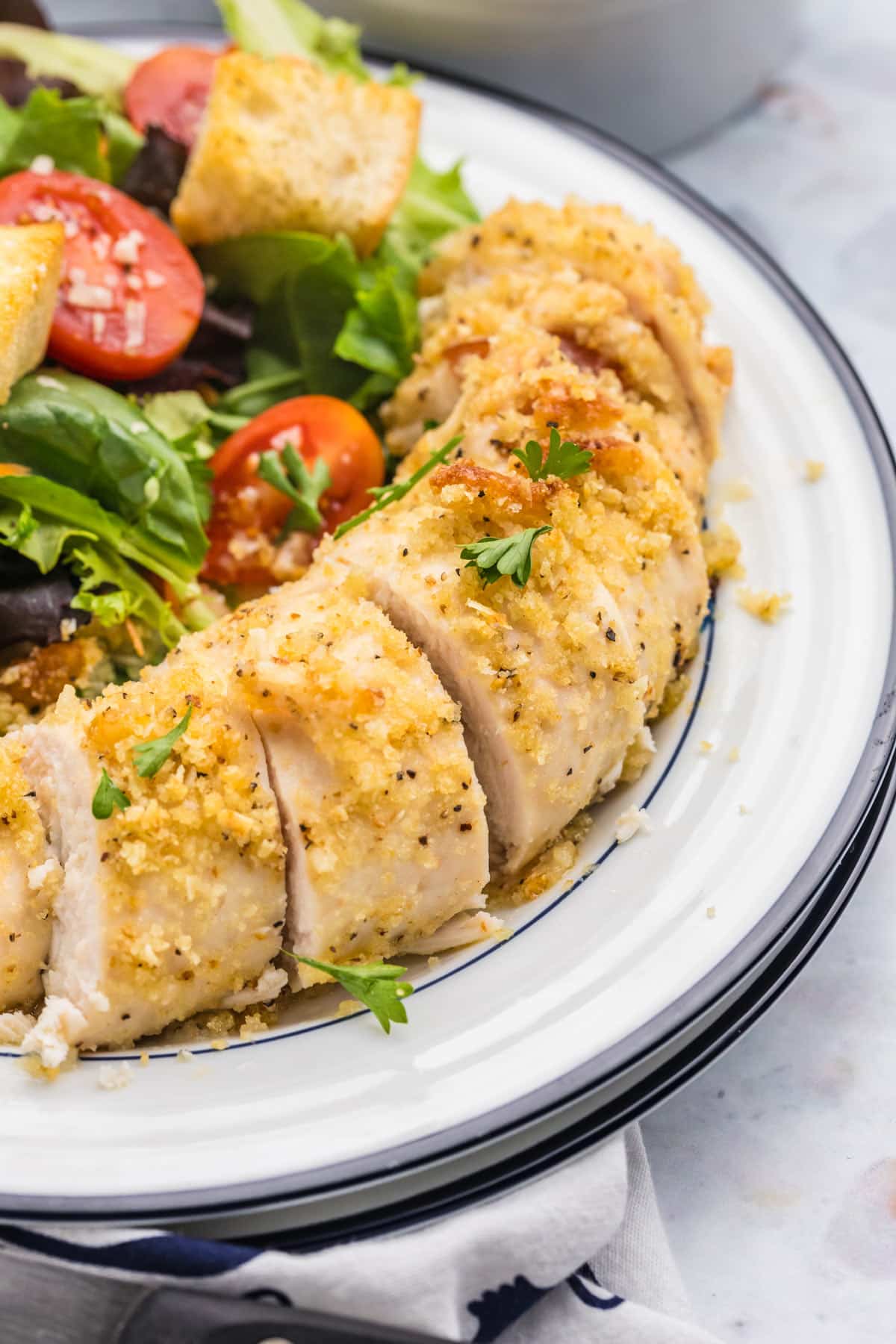 the sliced roll-ups on a plate with salad.