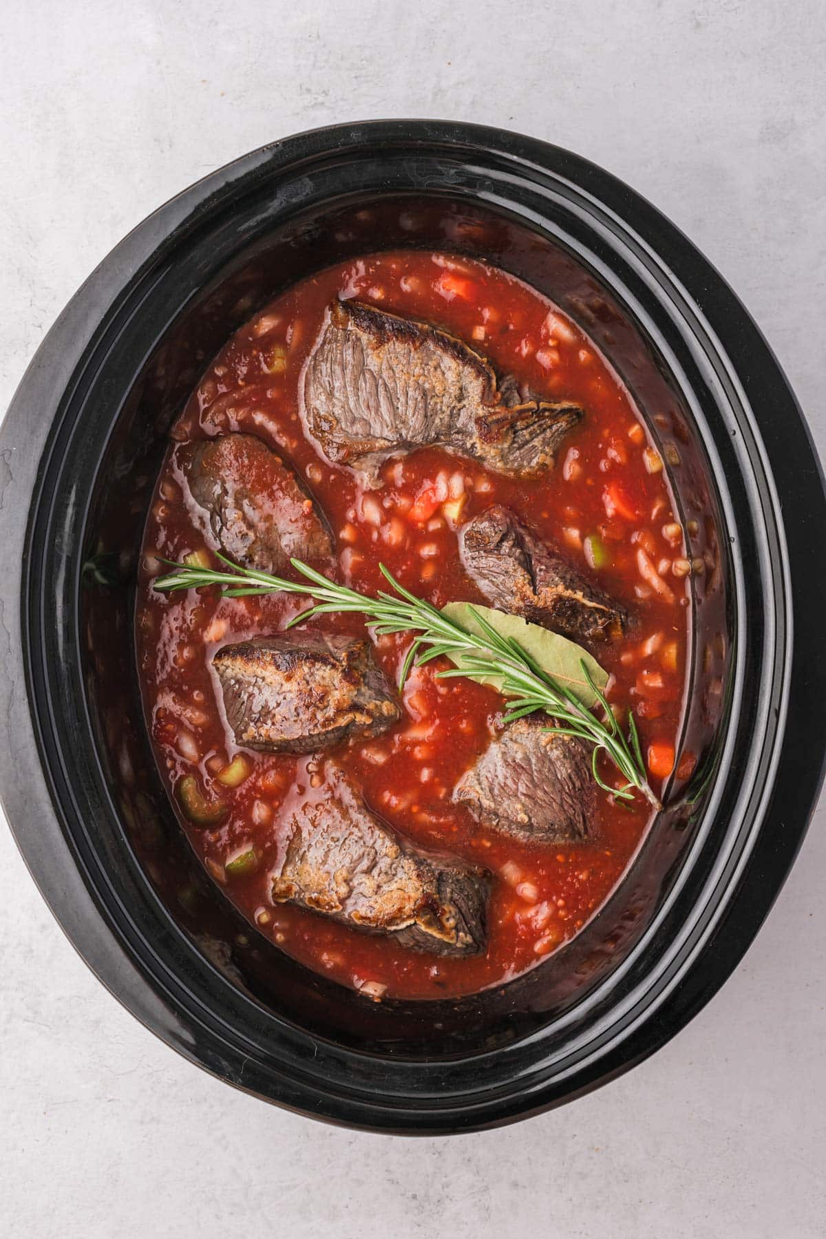 the short ribs in the sauce in the slow cooker.
