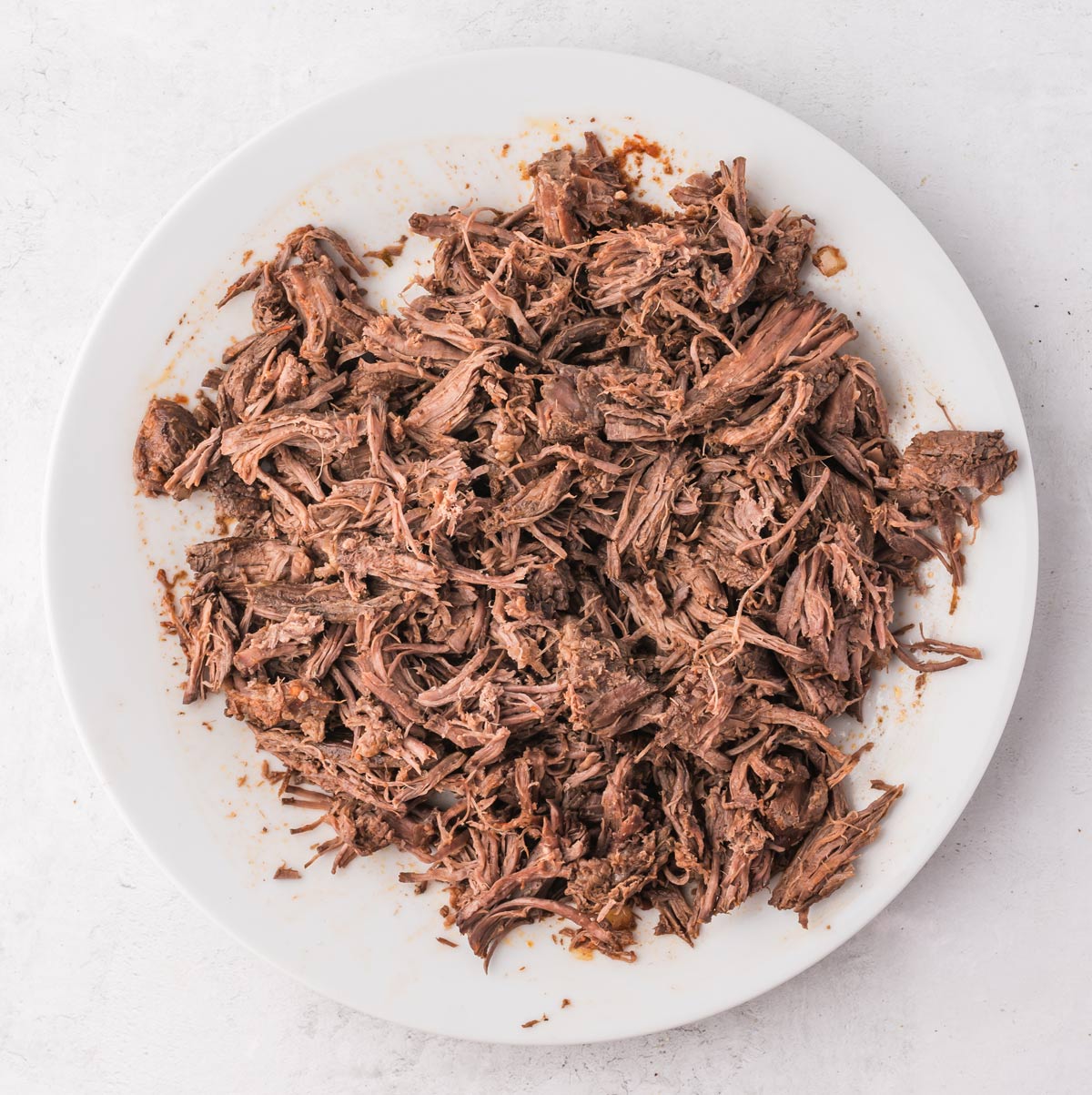 shredded short ribs on a plate.