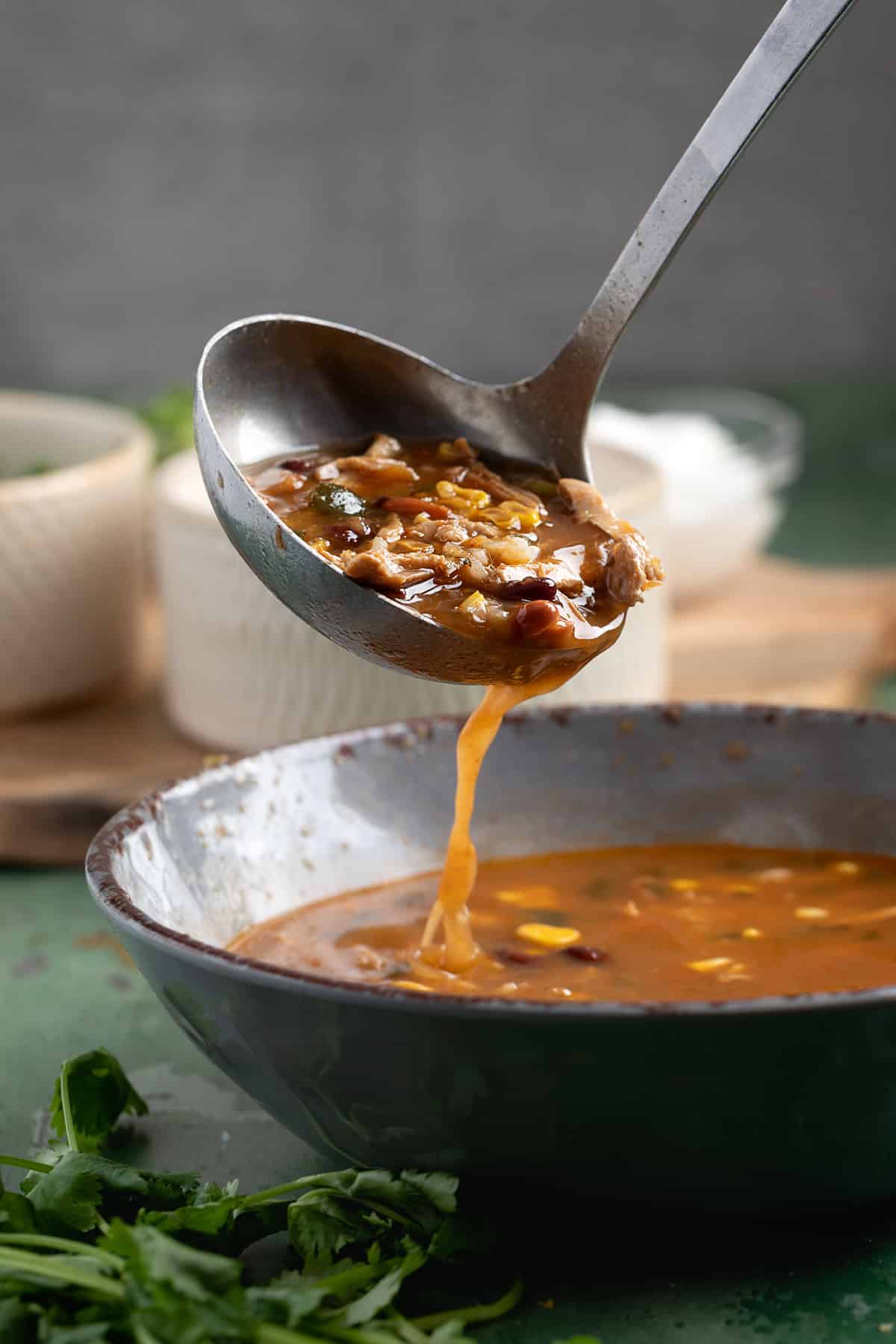 soup being ladled into a bowl.
