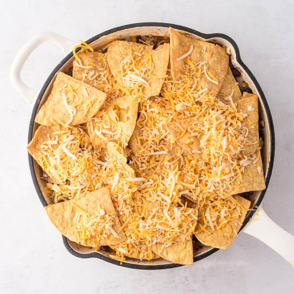 the chips and rest of the cheese layered on the skillet.