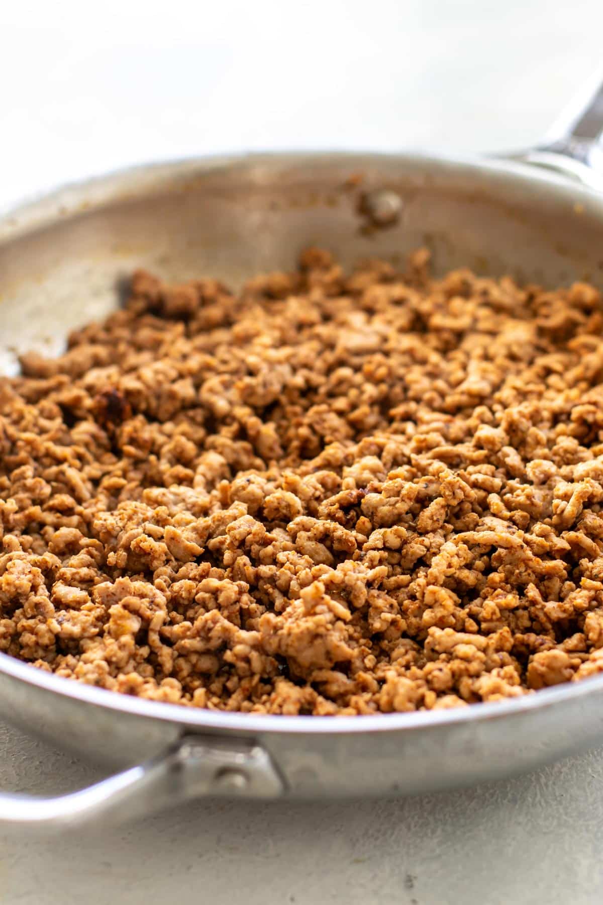 the seasoned pork in a pan.