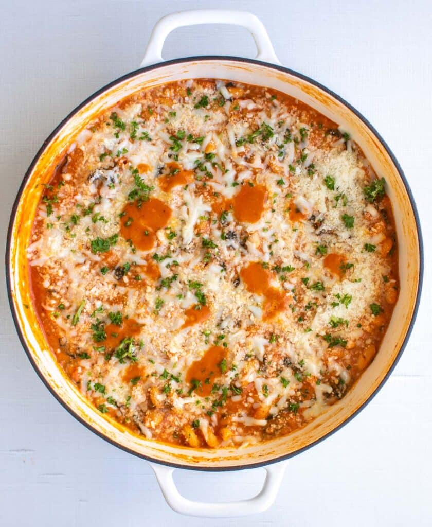 the bean pasta in the pan garnished with parsley.