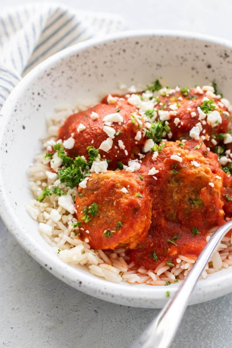 a bowl with rice and turkey meatballs with roasted red pepper tomato sauce.