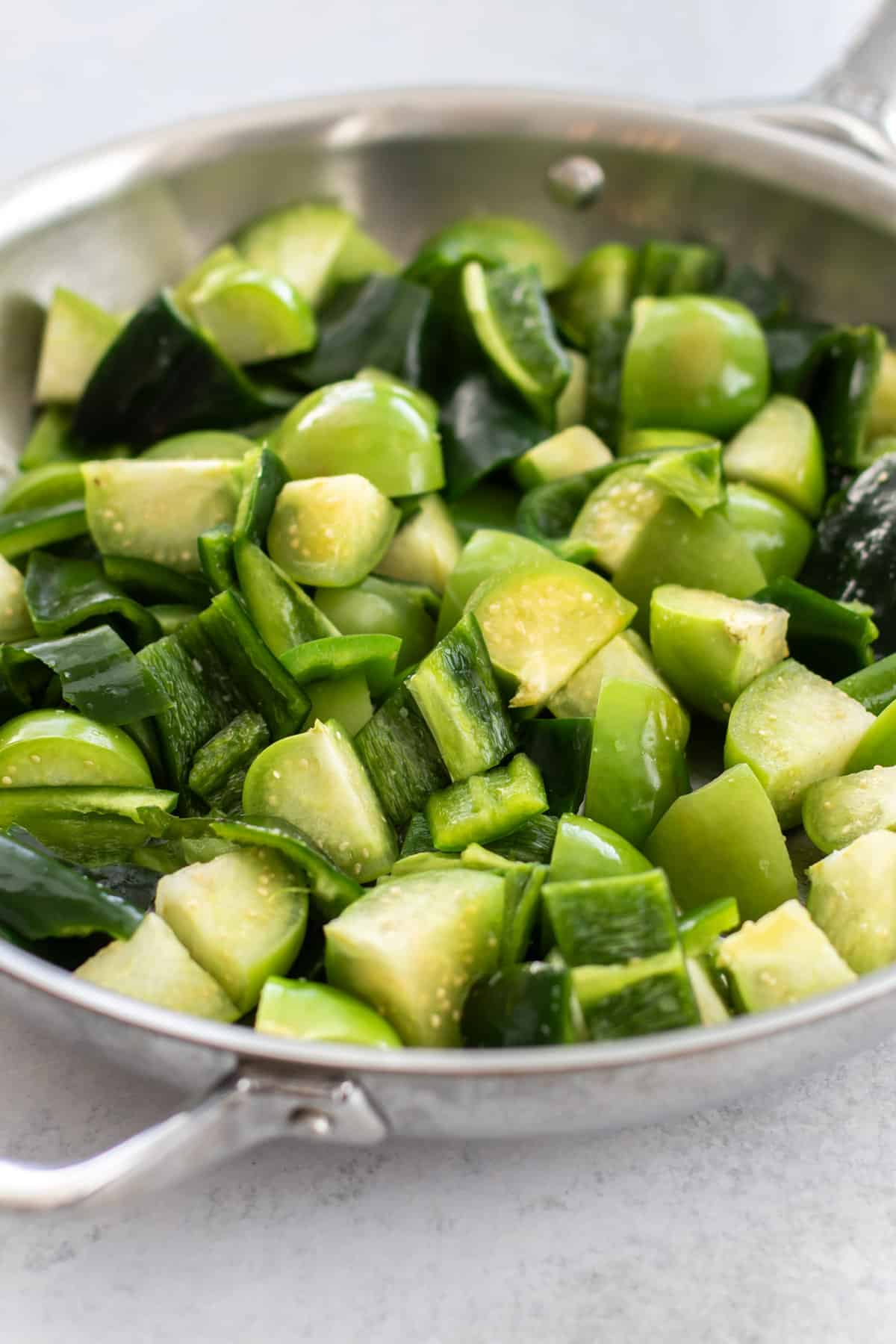 the peppers and tomatillos added to the pan.