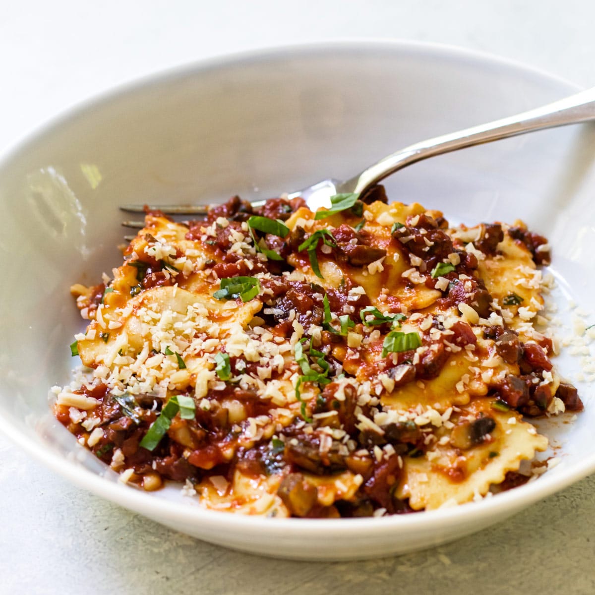 a bowl of pasta with sauce.