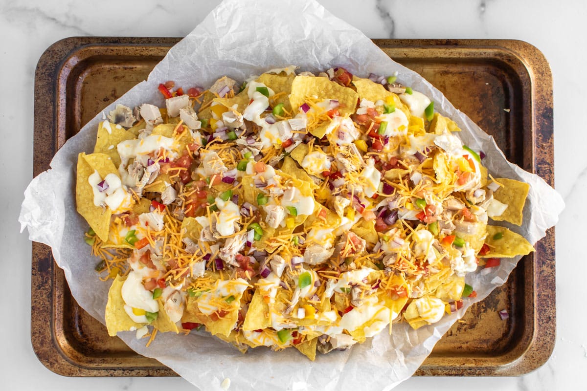 the assembled nachos on a sheet pan.