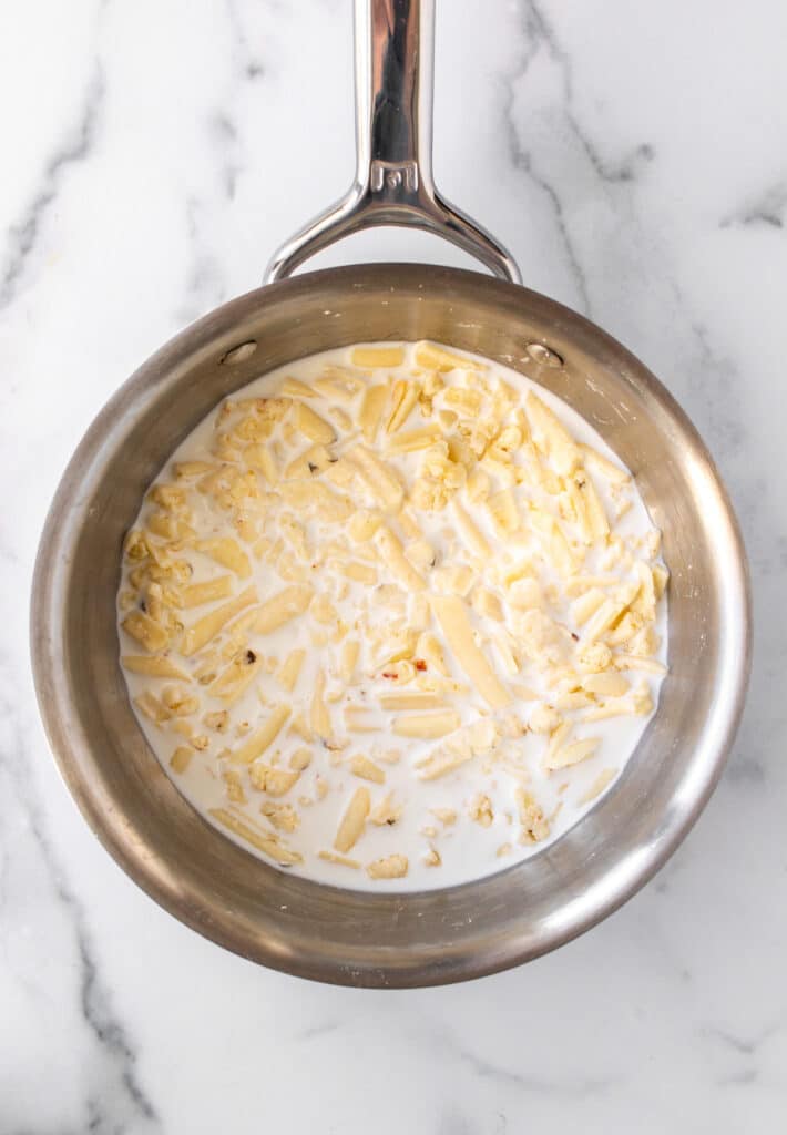 the cheese, cornstarch, and shredded cheese in a saucepan.