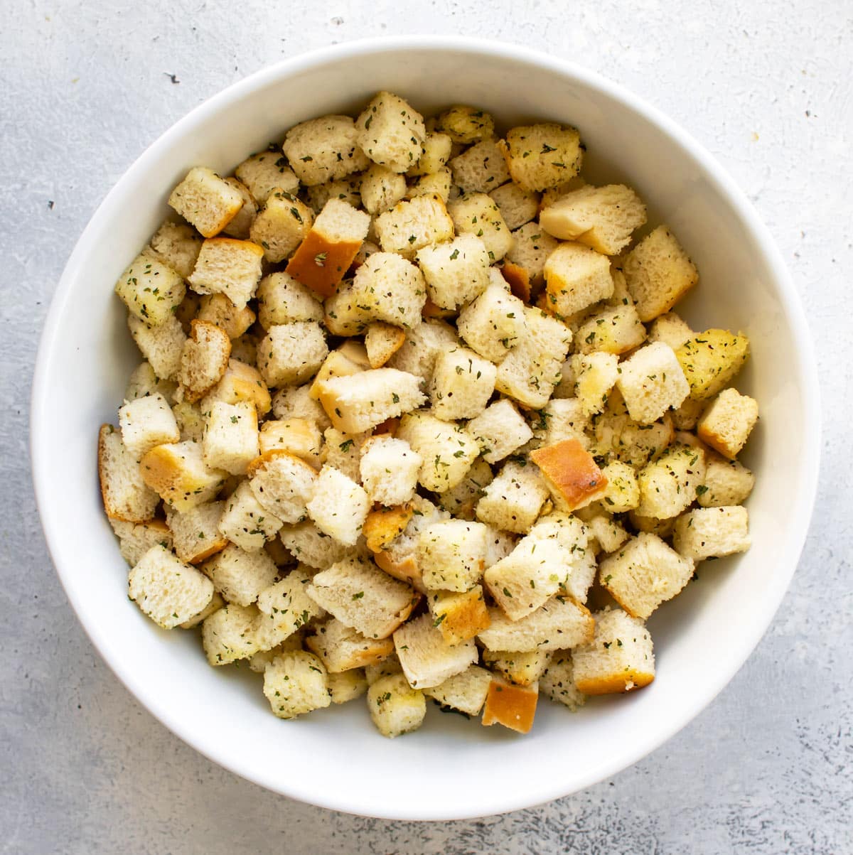 cubed bread coated in oil and seasonings.