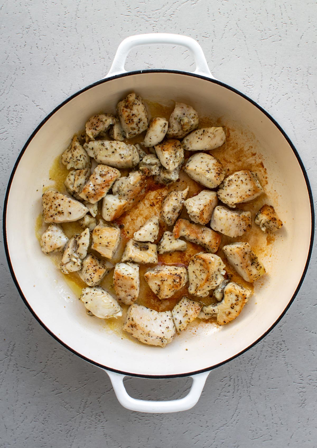 the browned chicken in the pan.