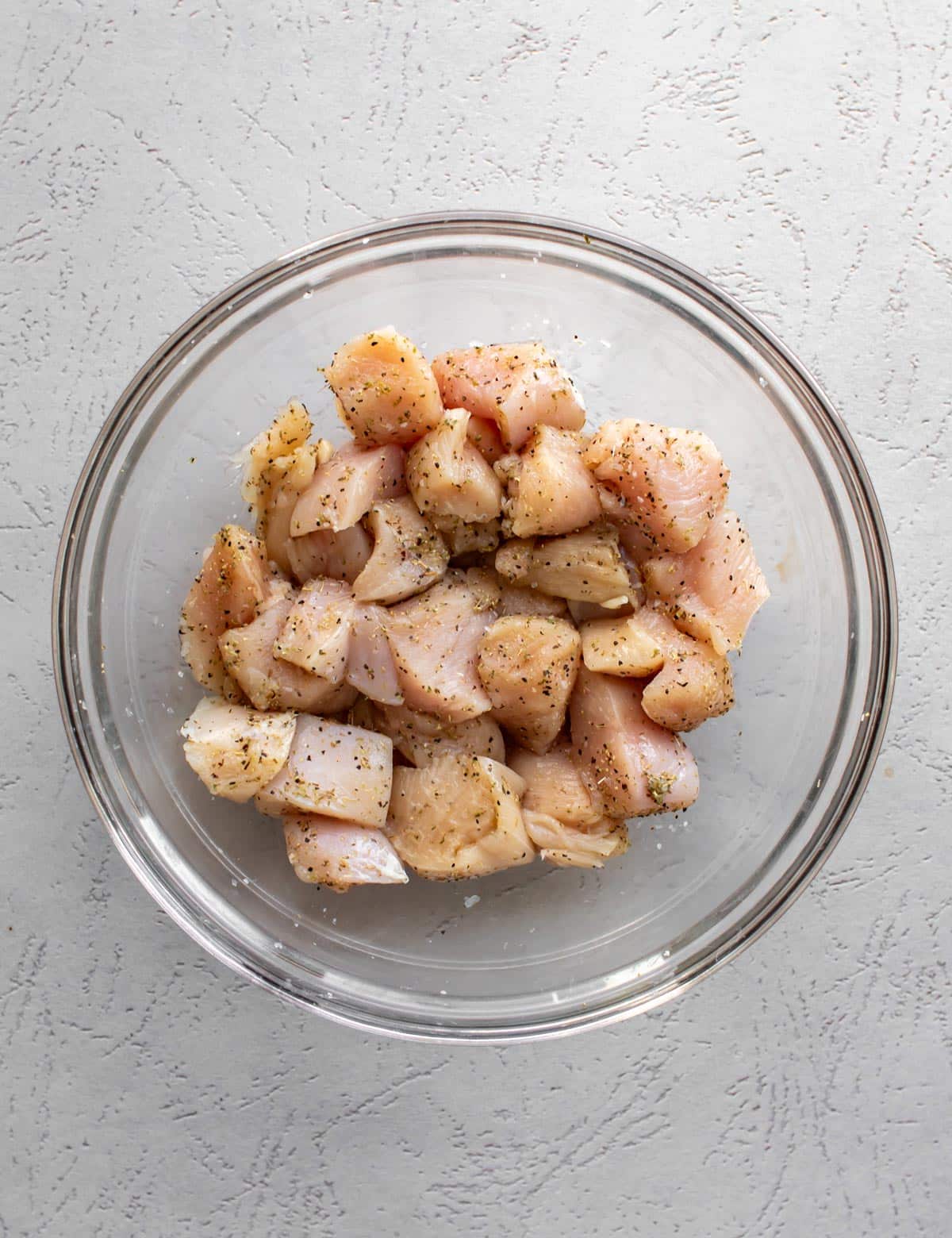 the seasoned chicken cubes in a bowl.
