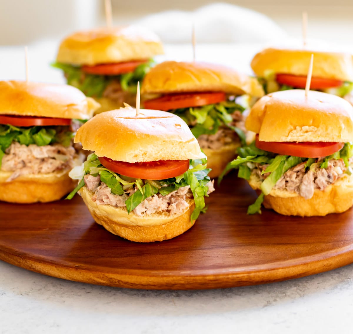 mini tuna sandwiches on a platter.