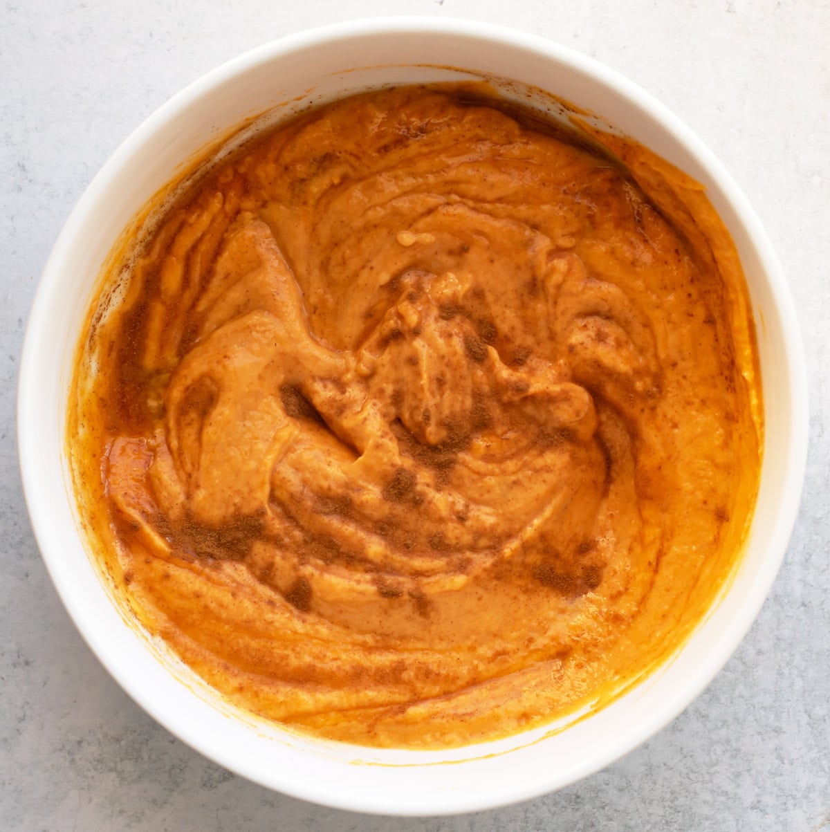 the pumpkin, yogurt and cinnamon mixed in a bowl.