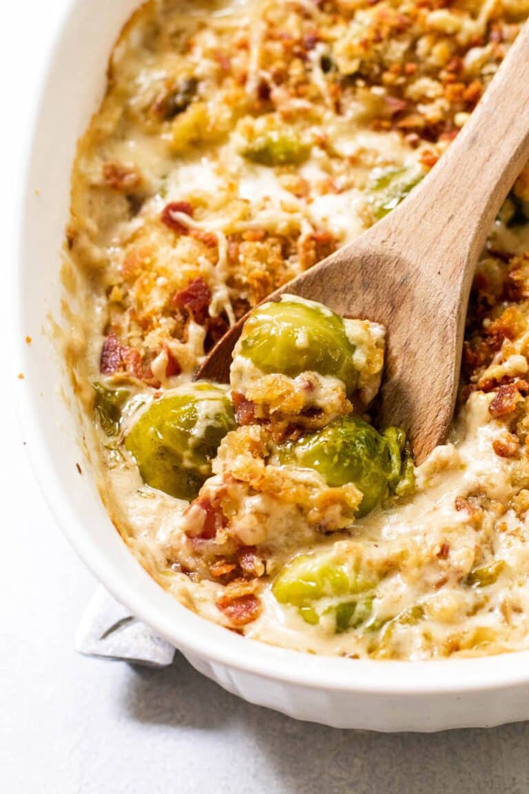 the sprouts gratin in a dish with a wooden spoon.