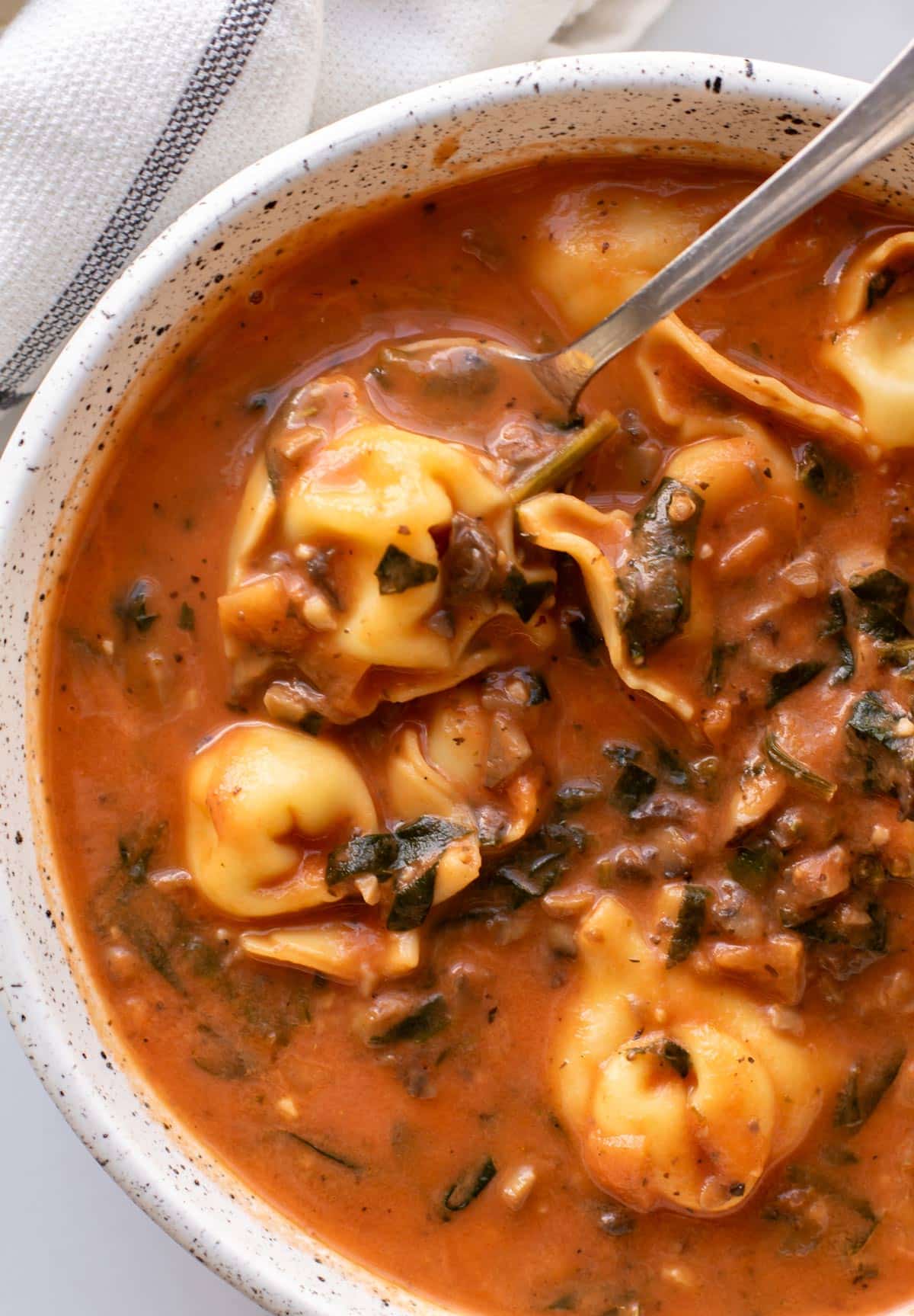 a bowl of tortellini soup.