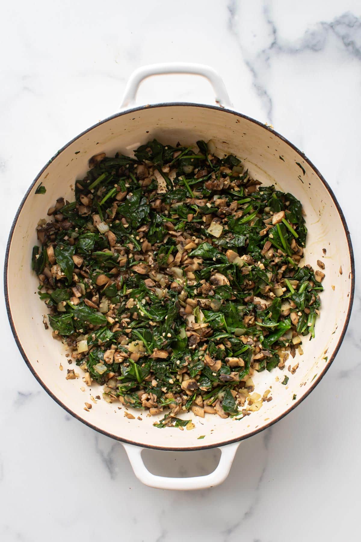 the spinach and mushrooms in a pan.