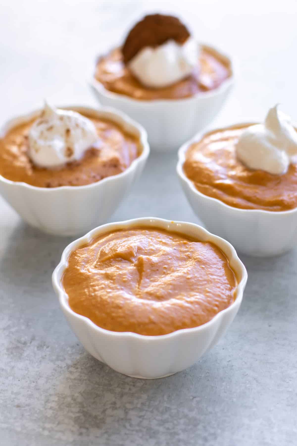 a bowl of pudding with others in the background.