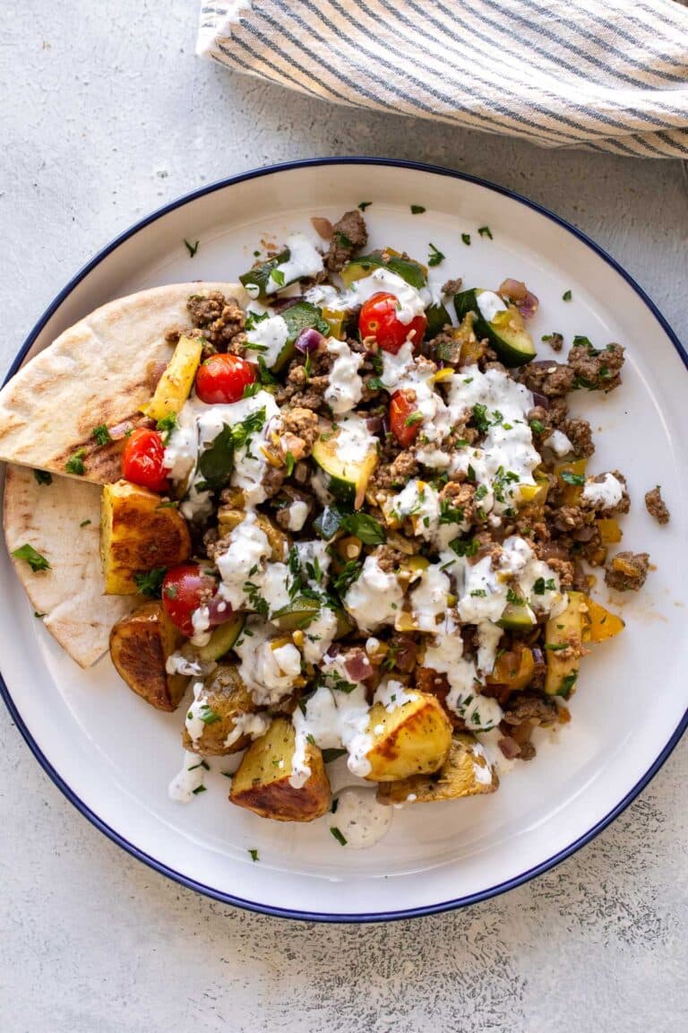 the finished dish on a plate with pita bread.