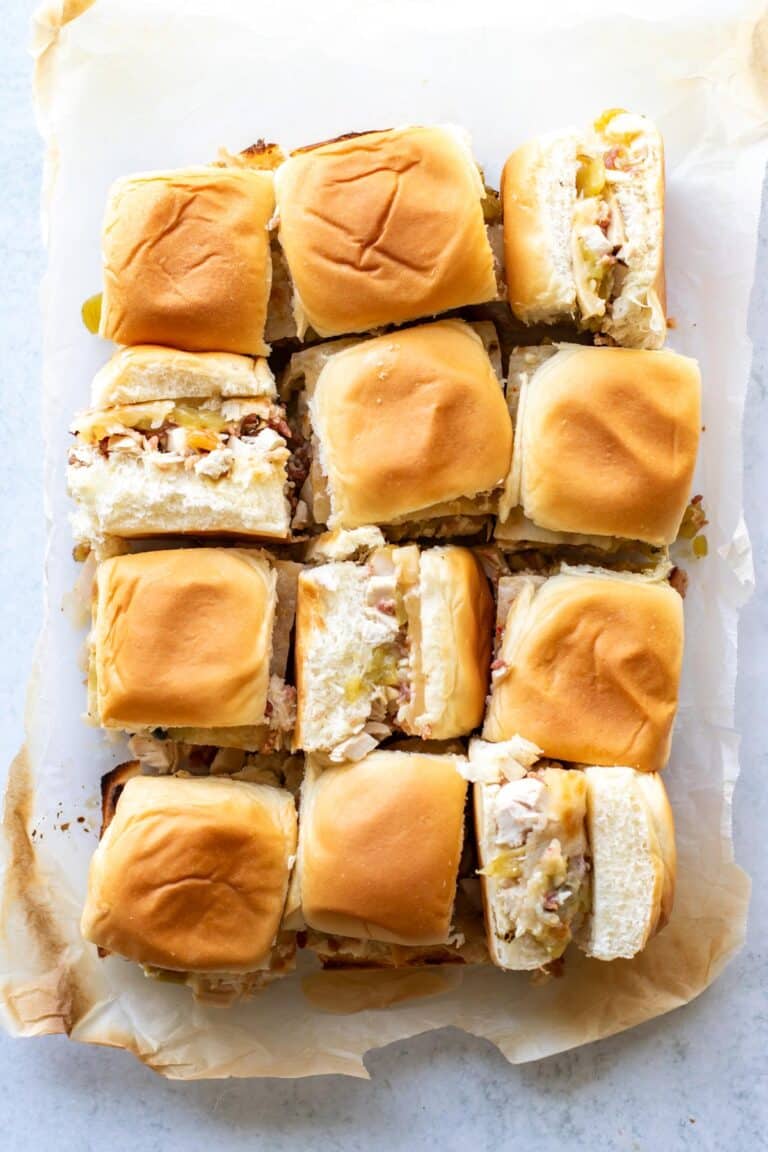 twelve green chile turkey sliders on a sheet pan.