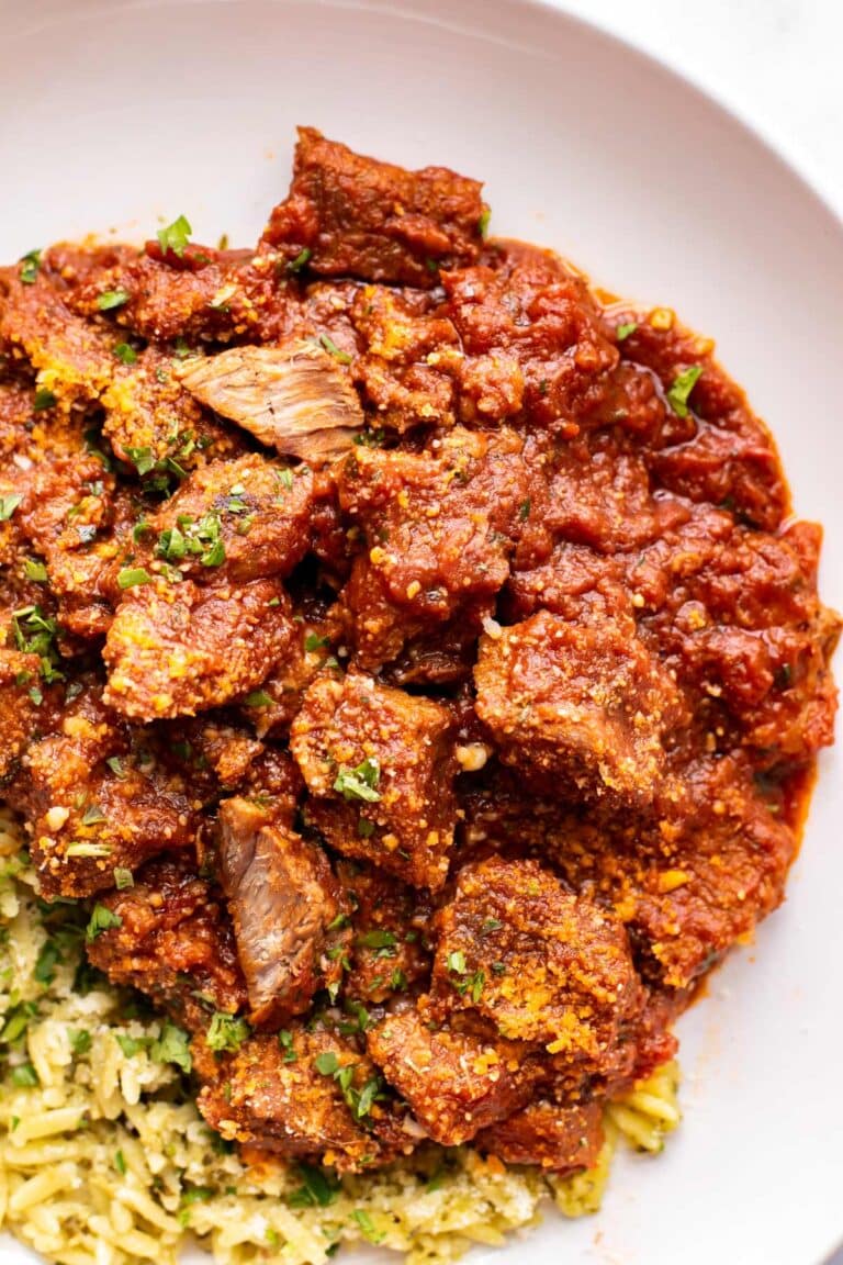 marinara beef on a plate with pasta.