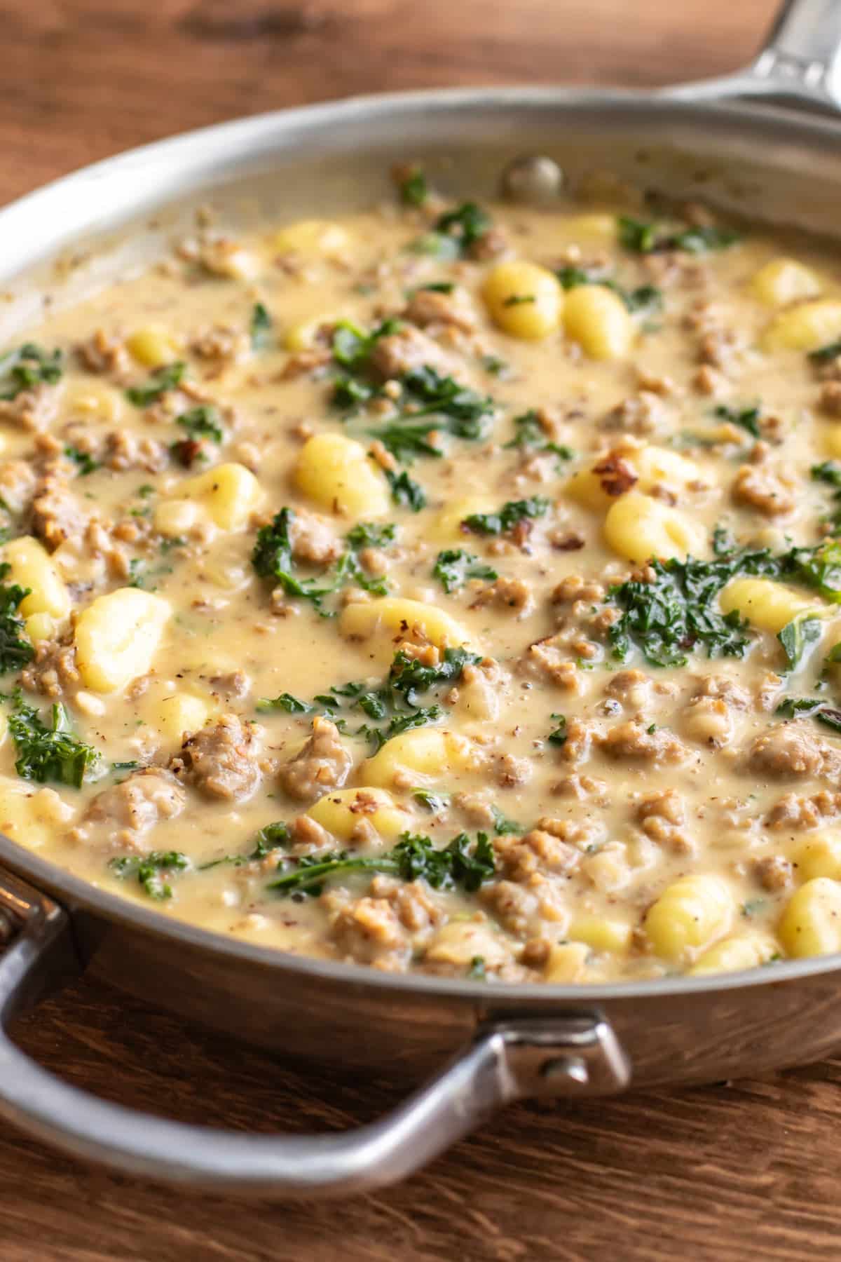 a pan of sausage gnocchi with kale.
