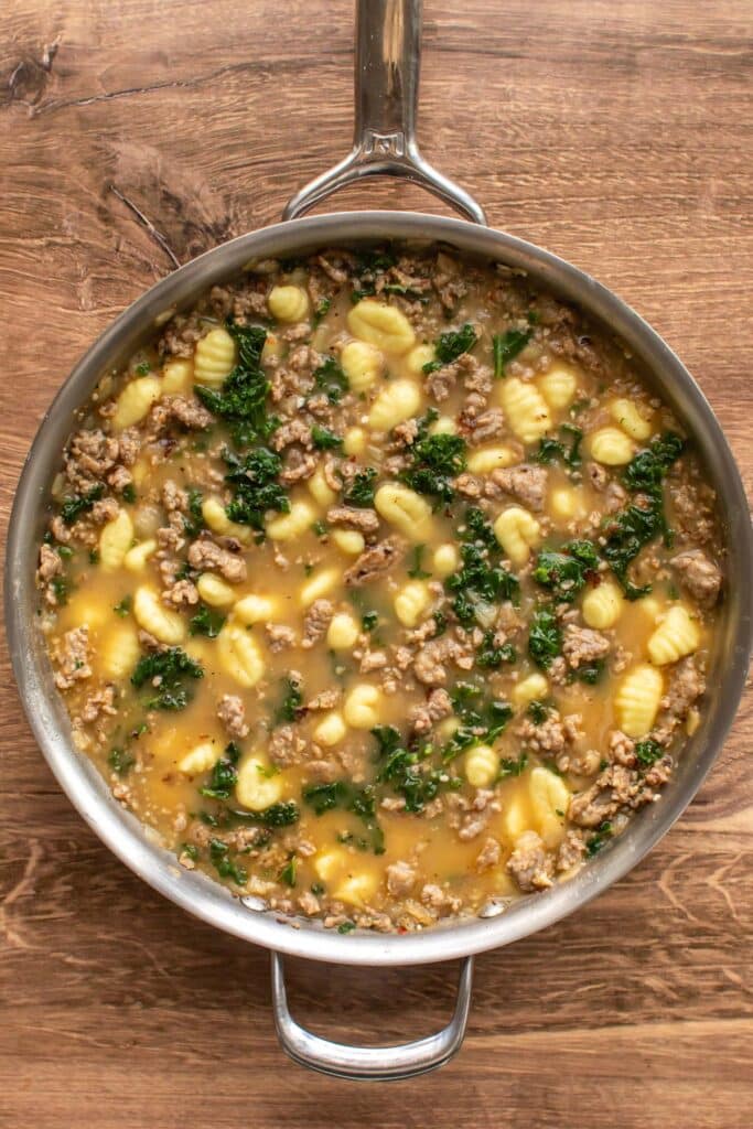 the cooked gnocchi in the broth.