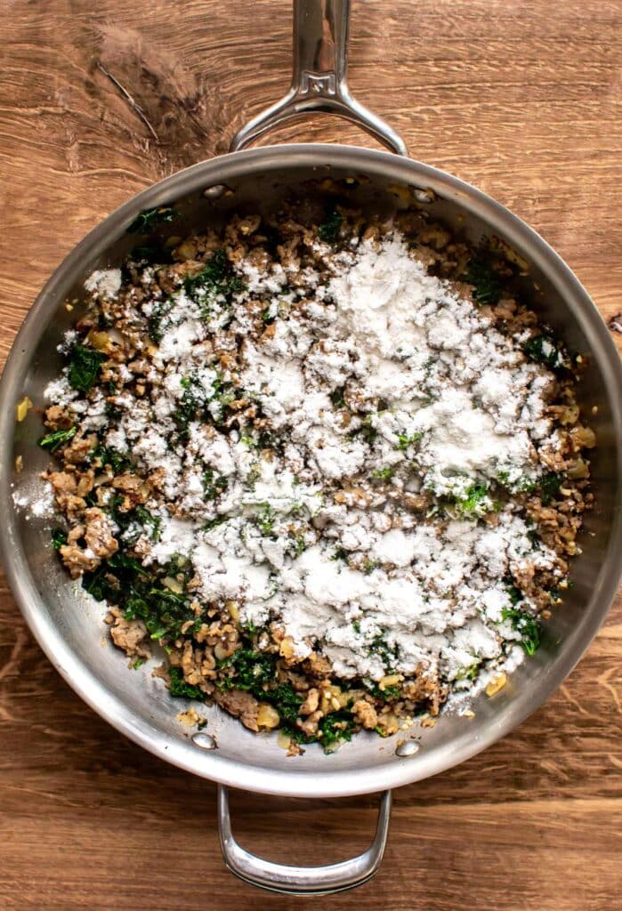 the flour sprinkled over the sausage and kale.
