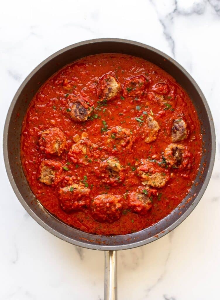 the meatballs simmering in the sauce.