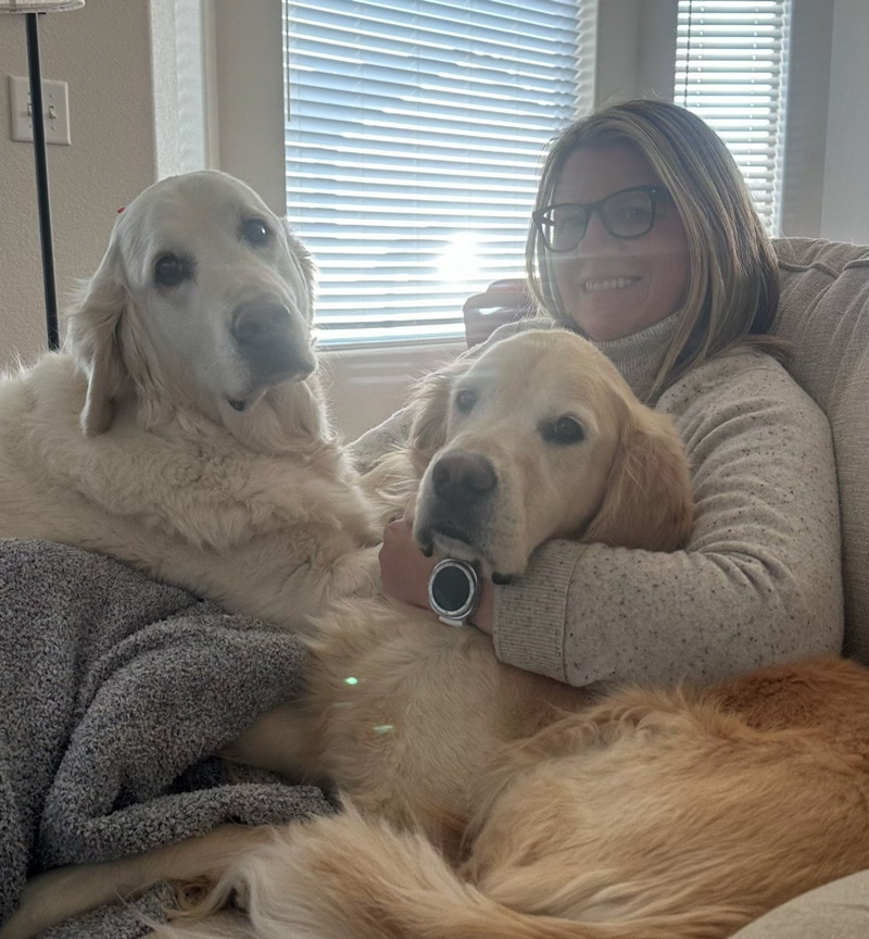 a girl with her two golden retrievers.