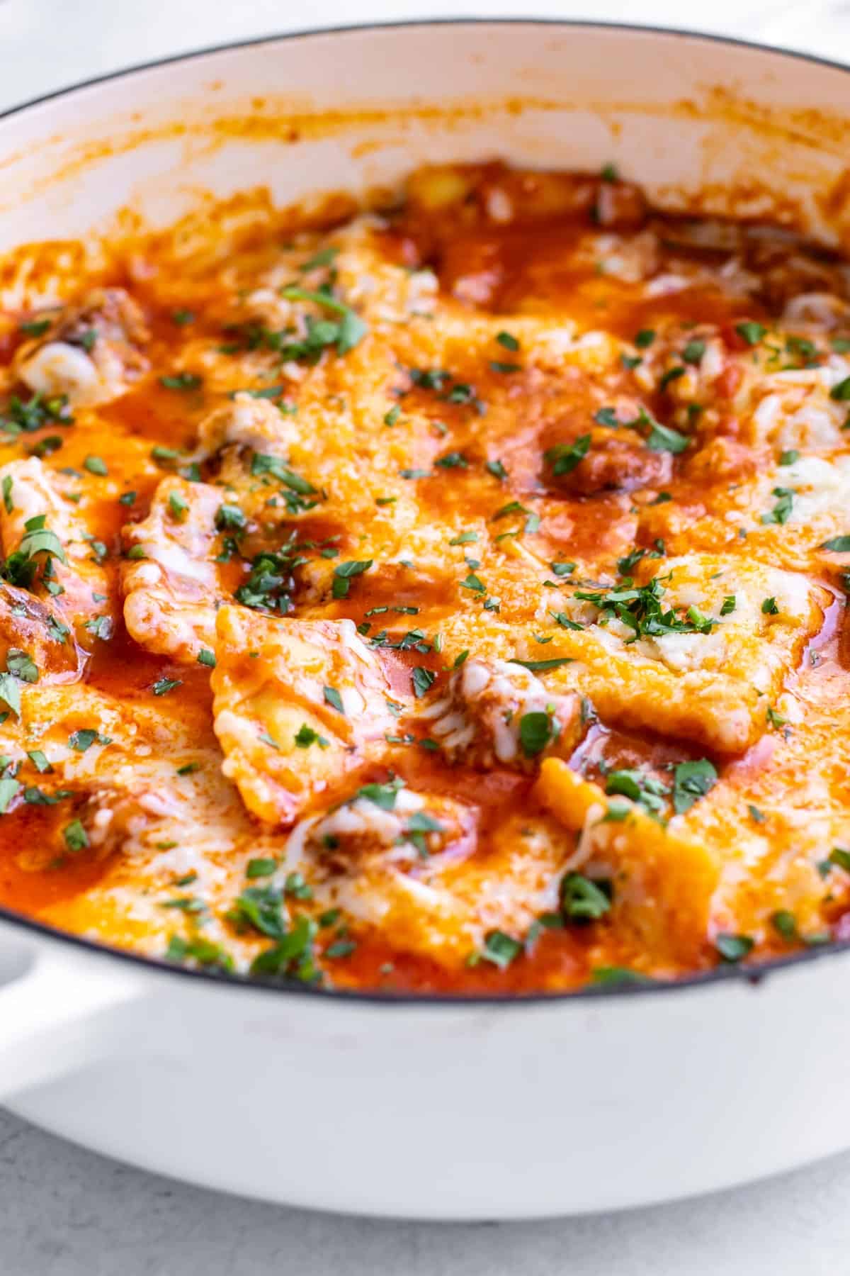 a pan of ravioli with sausage.