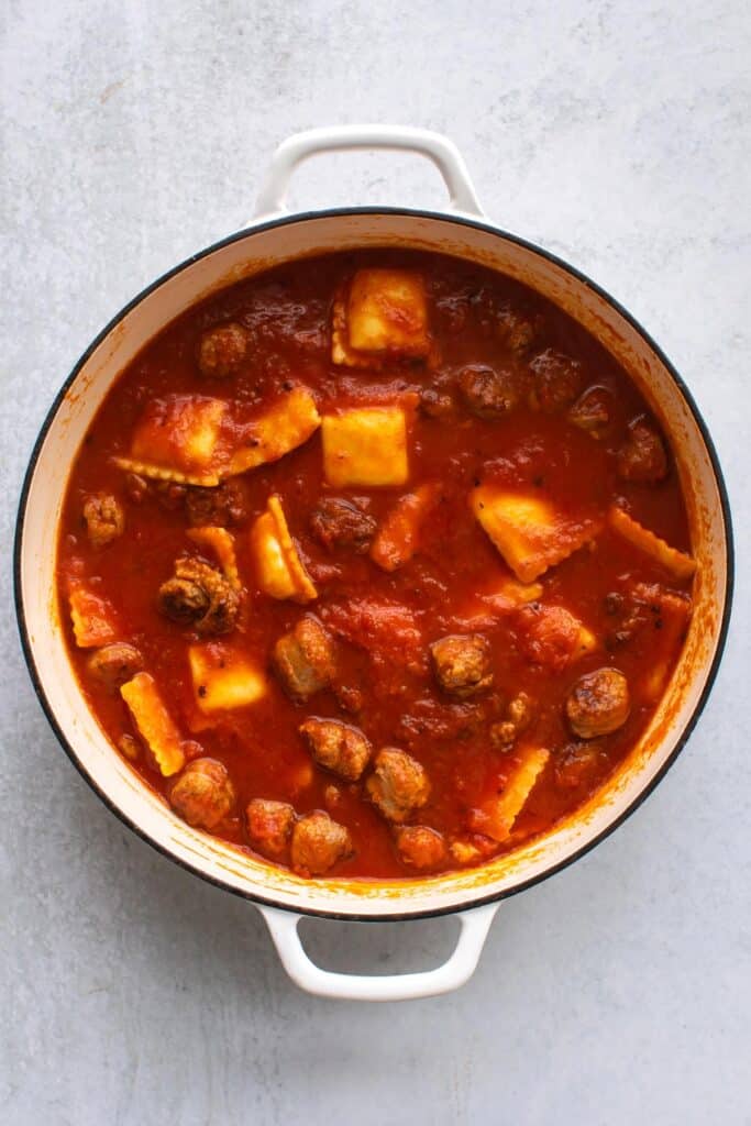 the sauce, pasta, and sausage in a pan.