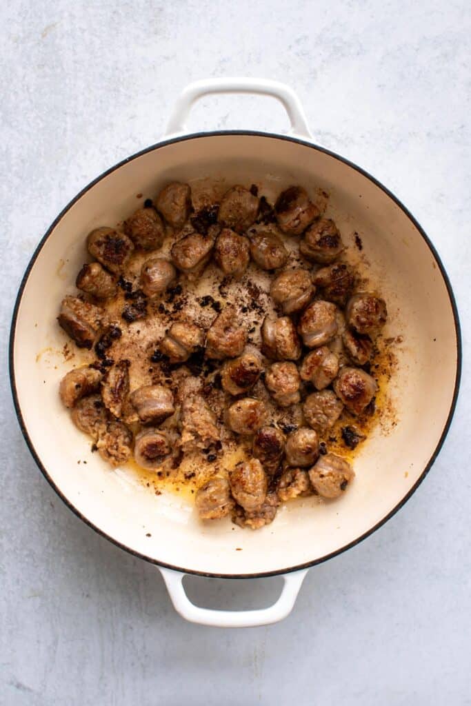 the browned sausage in a pan.
